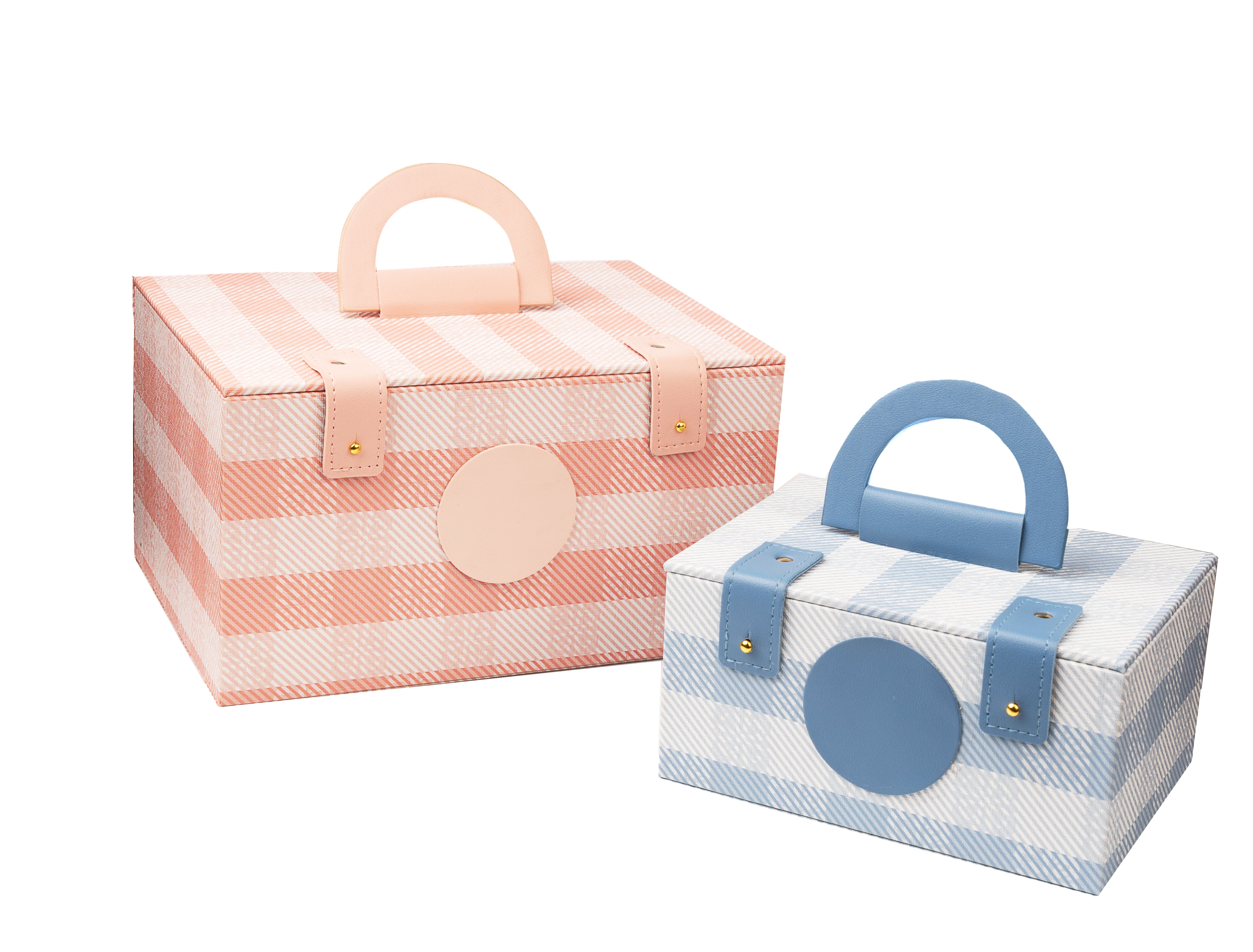 Two fabric storage boxes, one pink and white striped with a handle, the other blue and white striped with a handle, on a white background.